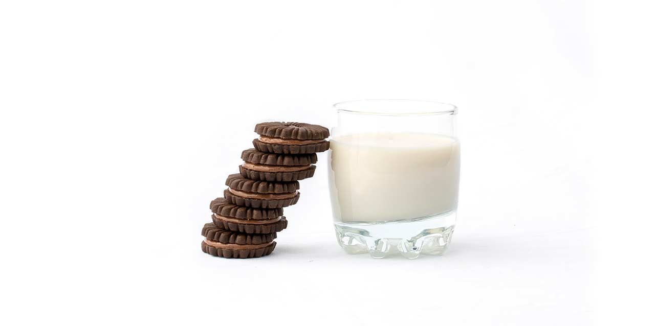 galletas rellenas apoyadas en vaso de agua galletas rellenas apoyadas en vaso de agua